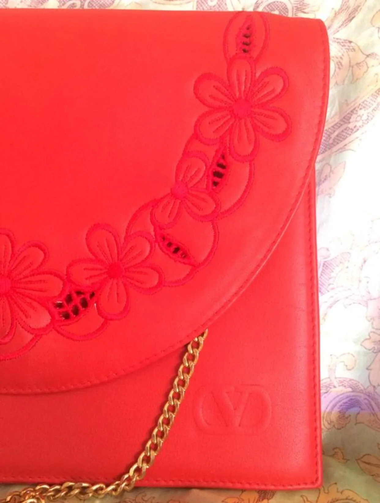 Vintage Valentino Garavani red leather clutch shoulder bag with red flower embroidery deco on the flap and V logo.