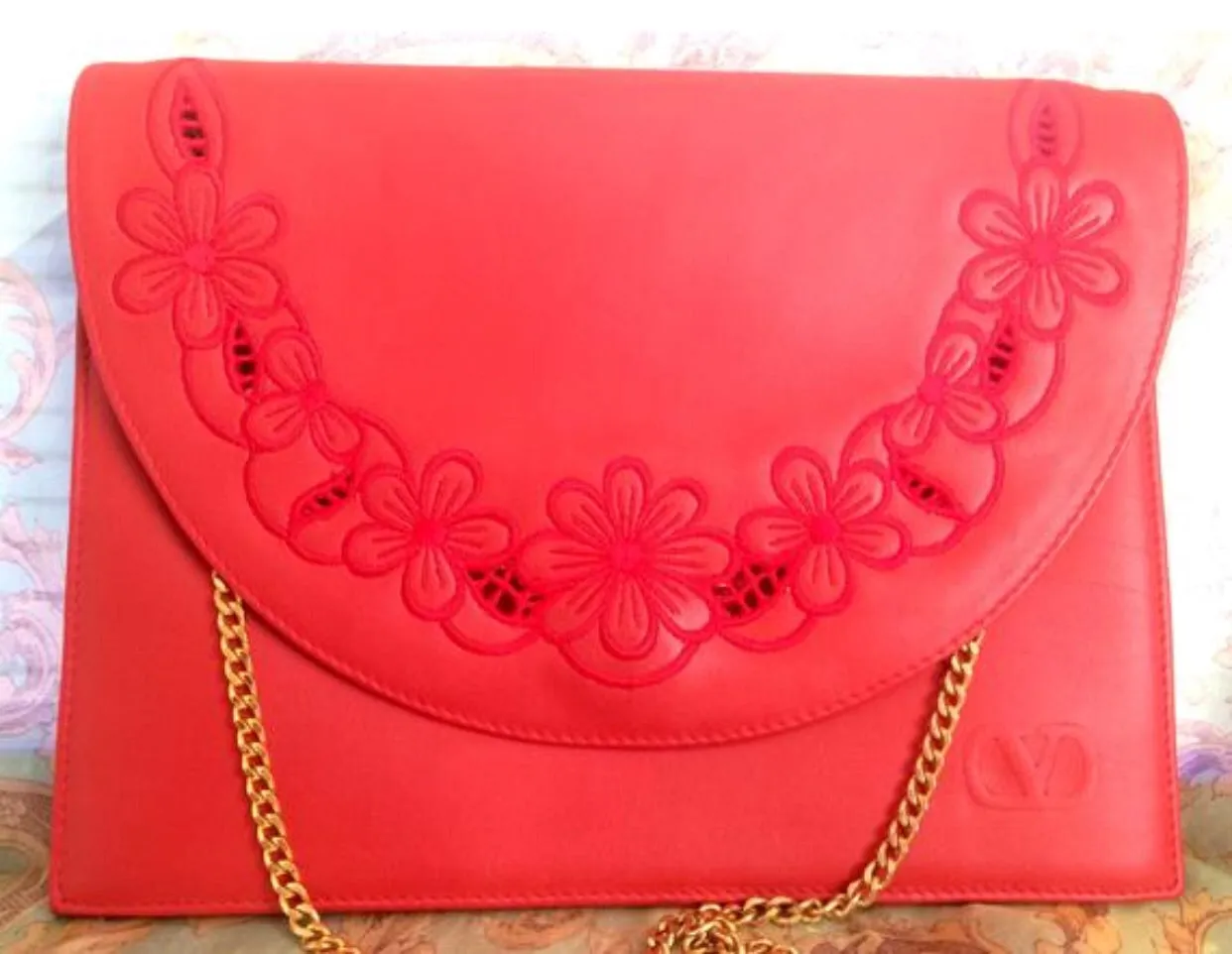 Vintage Valentino Garavani red leather clutch shoulder bag with red flower embroidery deco on the flap and V logo.